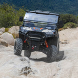 Dengao PowerSports RanchHawk 650FI riding an offroad trail and going over boulders.